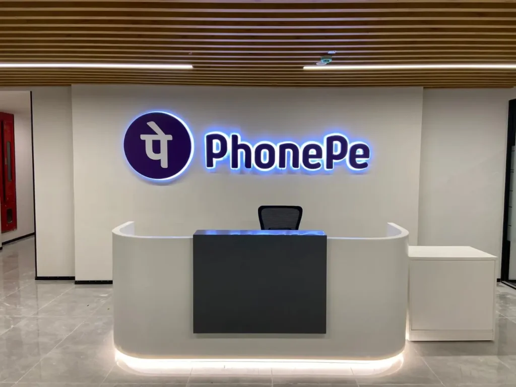 PhonePe office reception area with company logo illuminated on the wall