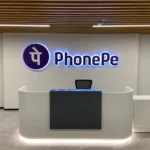 PhonePe office reception area with company logo illuminated on the wall
