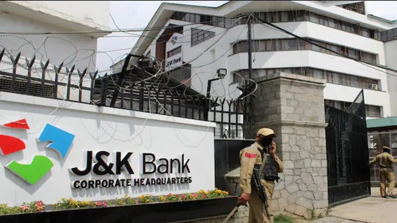 Security personnel outside the J&K Bank Corporate Headquarters building, showing the bank’s main entrance and signage.